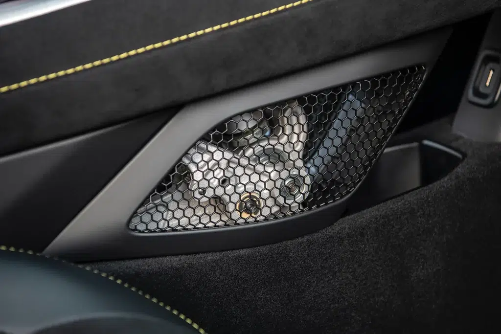 Nahaufnahme des freiliegenden Schaltgestänges mit Wabenmuster-Gitter im Innenraum eines Lotus Emira.